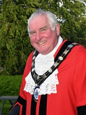 smiling man in mayoral robes