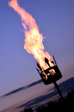 flaming beacon against dusk sky