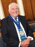 smiling suited man wearing deputy mayors chain of office