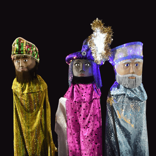 3 large king puppets on black background