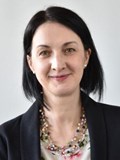 Headshot of smiling woman with dark hair